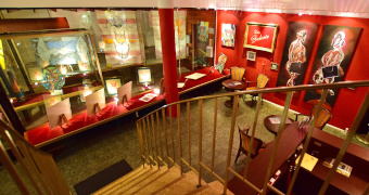 Blick in die Galerie mit Treppe und Gemälden an den Wänden