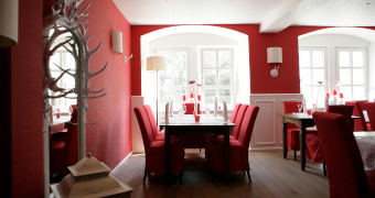 Blick in das Speisezimmer Jägerzimmer mit roter und weißer Einrichtung