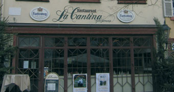 Schöne Eingangsfront aus Holz und Glas mit dem Schriftzu "La Cantina" an der Fassade.